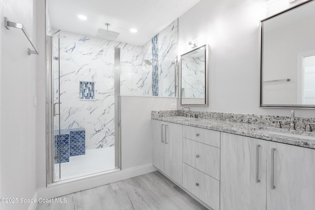 bathroom with vanity, hardwood / wood-style flooring, and walk in shower