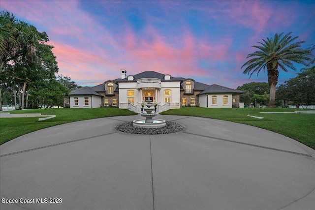 french provincial home featuring a yard