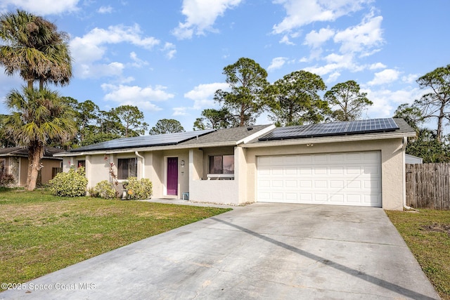 single story home with a garage, a front yard, and solar panels