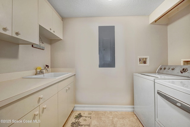 laundry area with washer and dryer, sink, cabinets, electric panel, and a textured ceiling