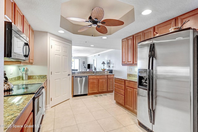 kitchen with ceiling fan, stainless steel appliances, a textured ceiling, and light tile patterned flooring