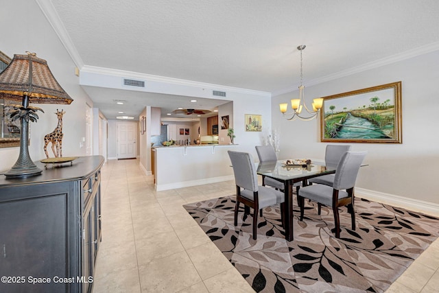 tiled dining space featuring crown molding, a chandelier, and a textured ceiling