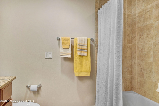 full bathroom with vanity, shower / bath combination with curtain, and toilet