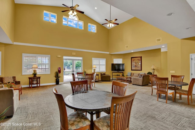 carpeted dining area with lofted ceiling and ceiling fan