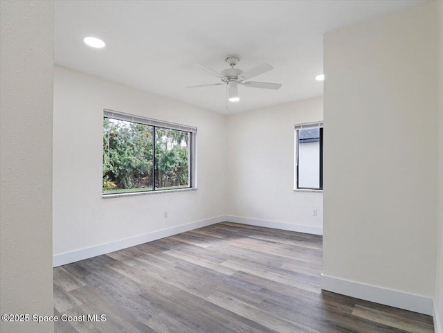 spare room featuring hardwood / wood-style flooring and ceiling fan