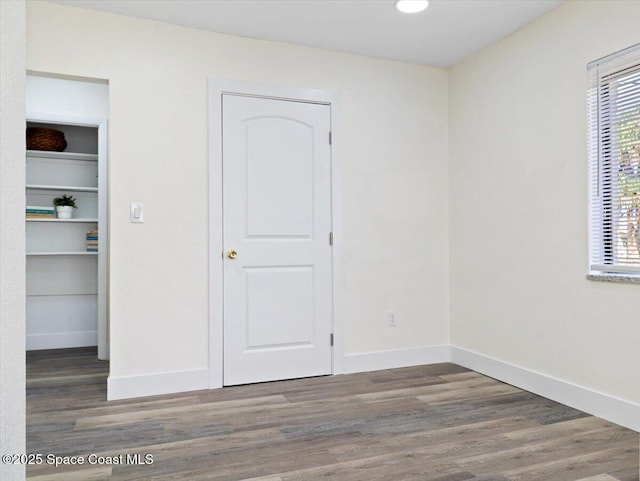 unfurnished bedroom featuring dark hardwood / wood-style flooring