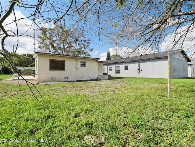 back of property featuring a lawn