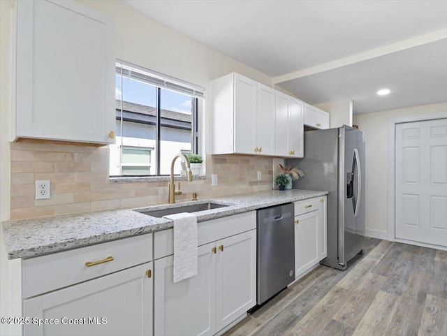 kitchen with white cabinetry, stainless steel appliances, and sink