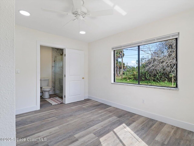 unfurnished room with ceiling fan and hardwood / wood-style floors