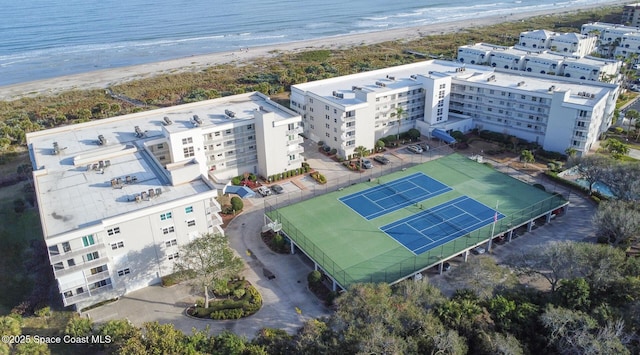 drone / aerial view featuring a water view and a beach view