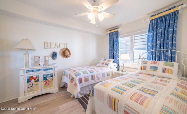 bedroom with ceiling fan and light wood-type flooring