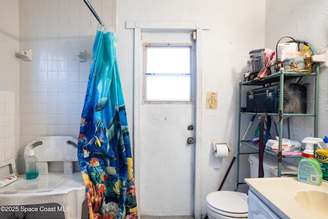 bathroom featuring vanity, curtained shower, and toilet