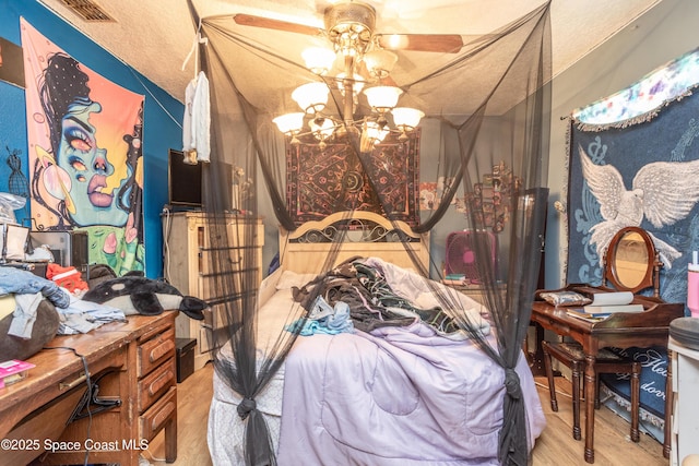 bedroom with an inviting chandelier and light hardwood / wood-style floors