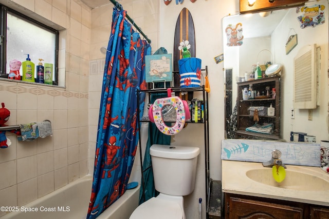 full bathroom with vanity, shower / tub combo, and toilet