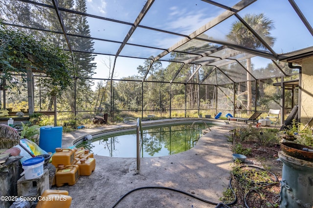 view of swimming pool featuring glass enclosure and a patio area