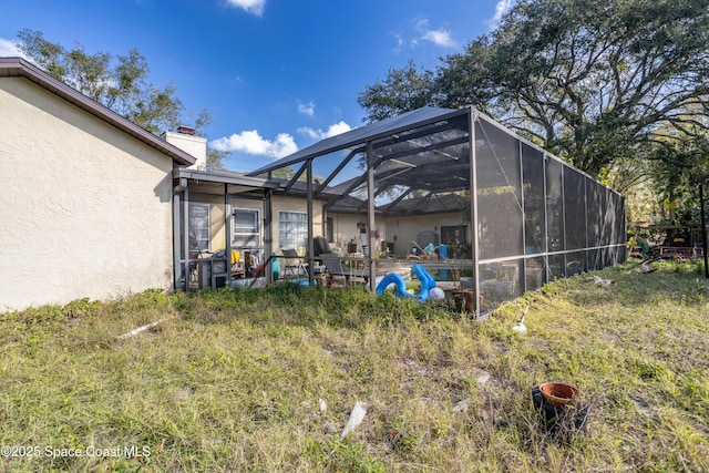 view of yard with glass enclosure