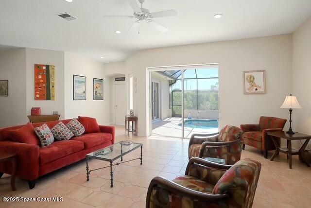 tiled living room with ceiling fan