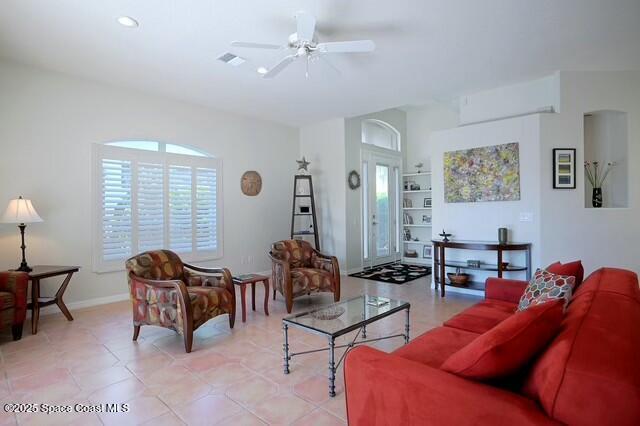 living room featuring built in features and ceiling fan