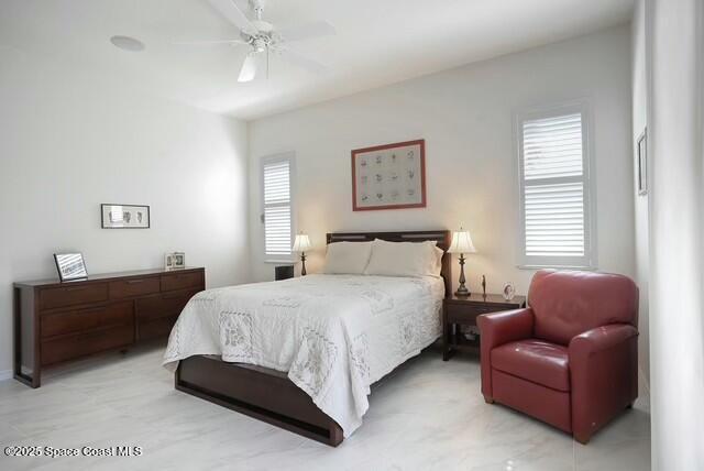 bedroom featuring multiple windows and ceiling fan