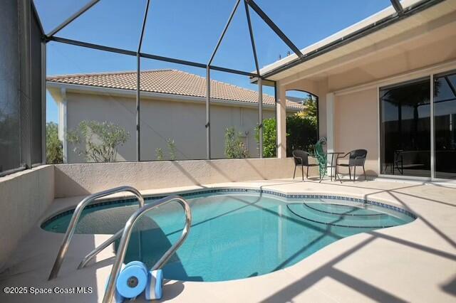 view of pool with a lanai and a patio area