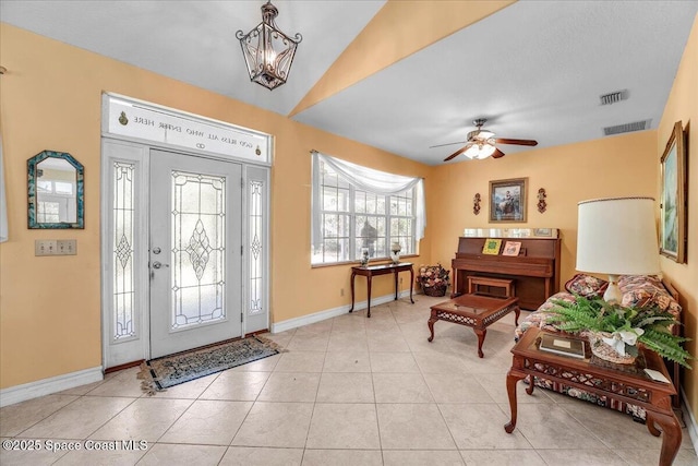 tiled entrance foyer featuring lofted ceiling and ceiling fan