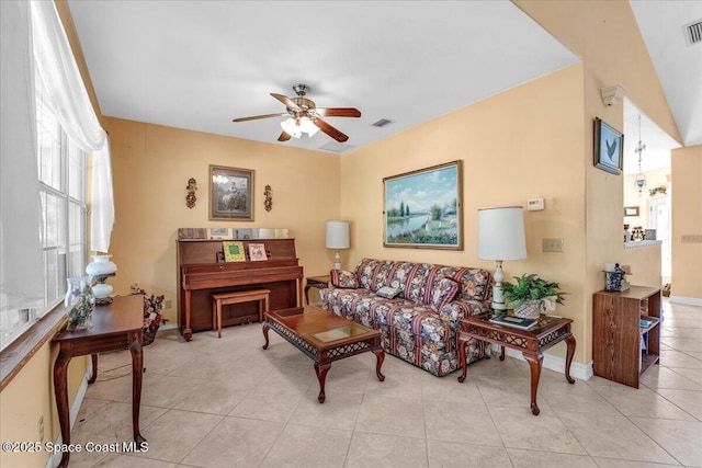 tiled living room featuring ceiling fan