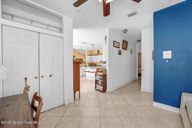 hall with light tile patterned floors