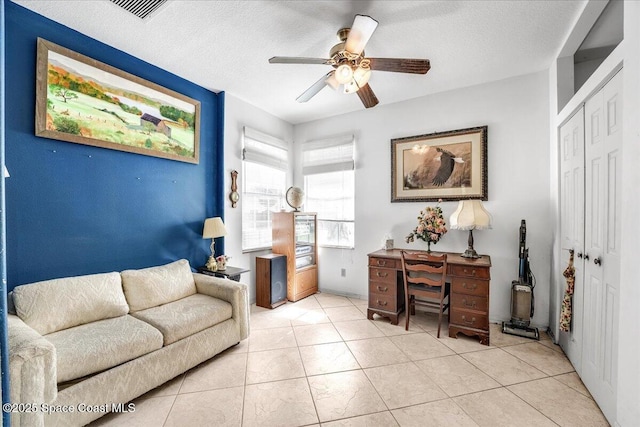 office with light tile patterned flooring, ceiling fan, and a textured ceiling