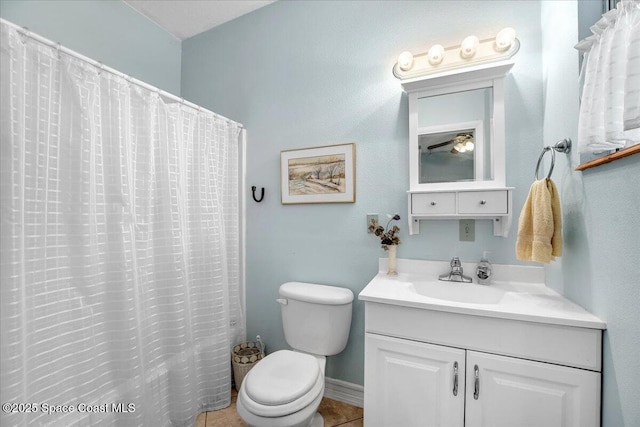 bathroom featuring tile patterned flooring, vanity, a shower with shower curtain, and toilet