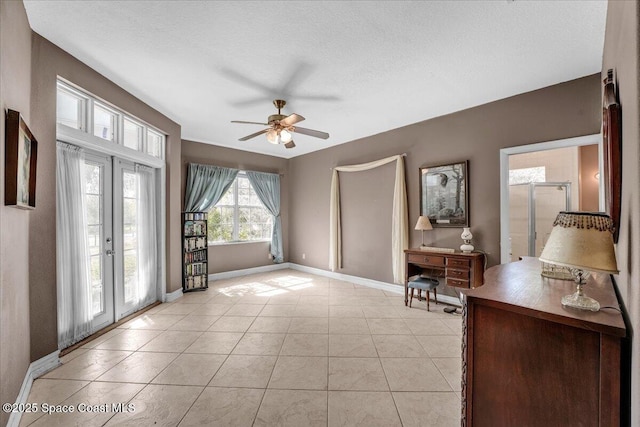 interior space with french doors, ceiling fan, a textured ceiling, and light tile patterned floors