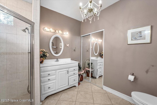 bathroom featuring a shower with shower door, vanity, toilet, tile patterned floors, and an inviting chandelier