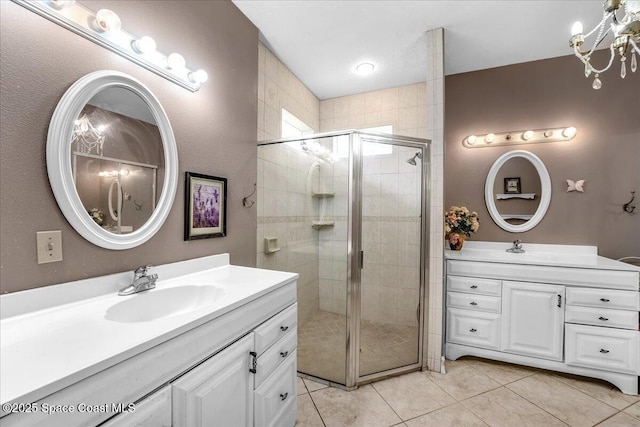 bathroom with tile patterned floors, vanity, and a shower with door