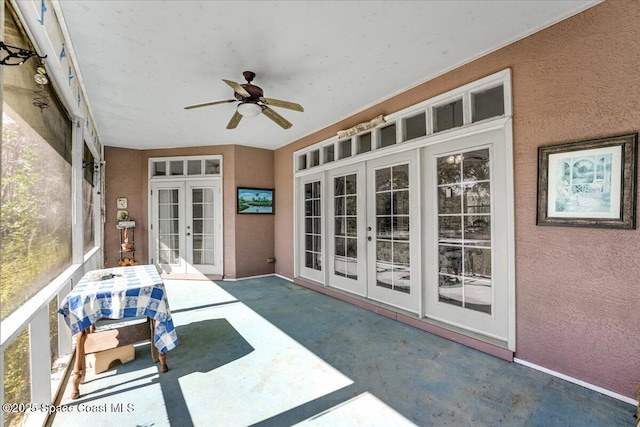 sunroom / solarium featuring french doors and ceiling fan