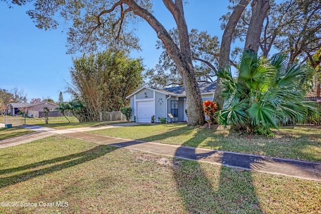 view of front of home featuring a garage and a front lawn