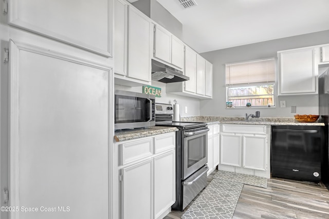 kitchen featuring sink, stainless steel appliances, light stone counters, white cabinets, and light wood-type flooring