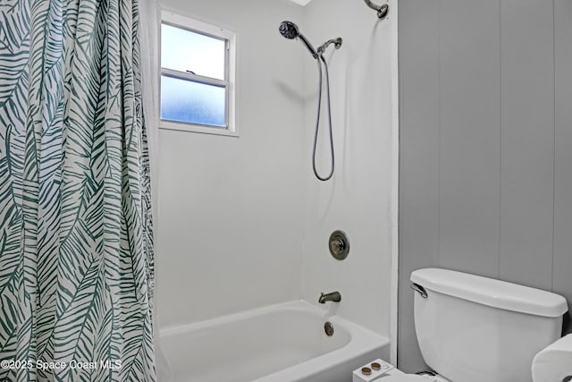 bathroom with toilet and shower / tub combo