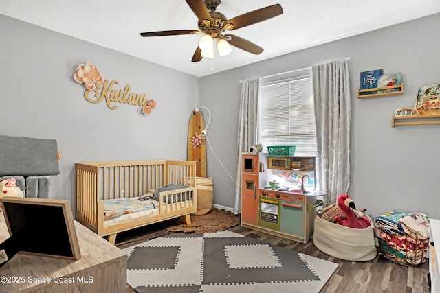 bedroom featuring hardwood / wood-style flooring and ceiling fan