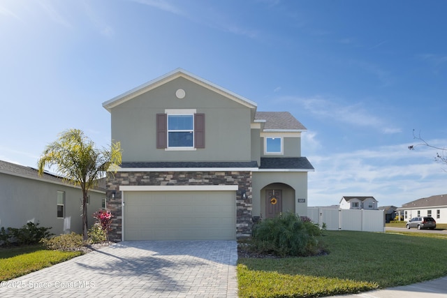 front of property featuring a garage and a front yard