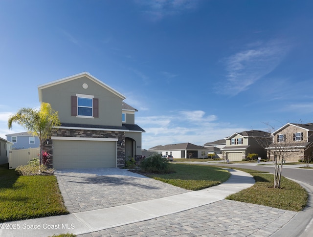 view of front of home featuring a garage and a front lawn