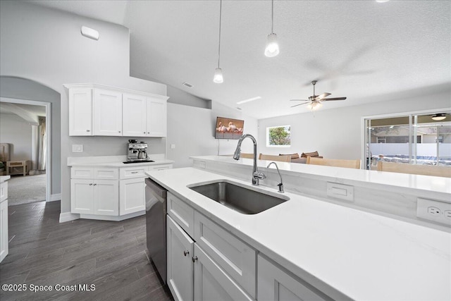 kitchen with white cabinetry, hanging light fixtures, sink, and dishwasher