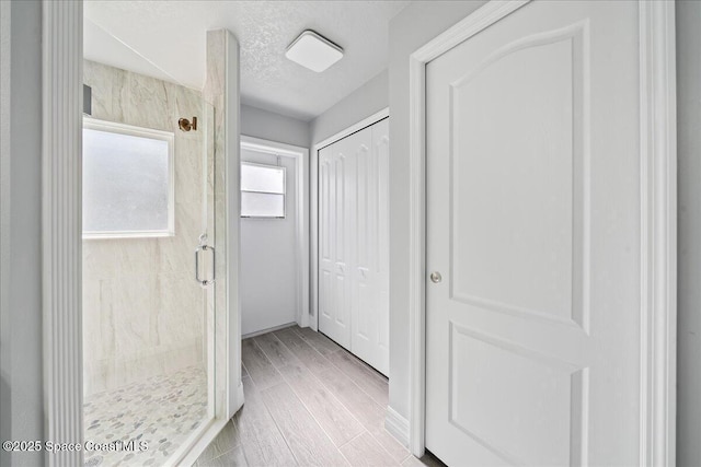 hall with a textured ceiling