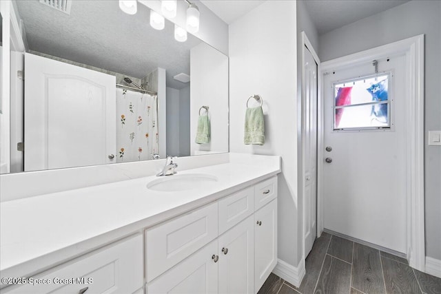 bathroom featuring vanity and a textured ceiling