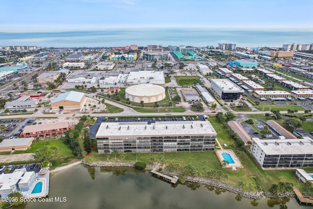 birds eye view of property featuring a water view and a view of city