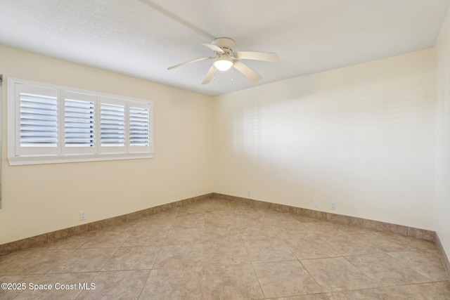 unfurnished room featuring light tile patterned floors, baseboards, and ceiling fan