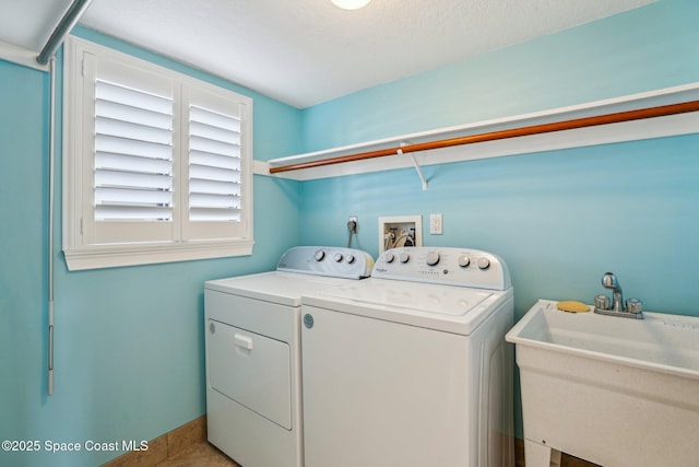 clothes washing area featuring a sink, independent washer and dryer, and laundry area