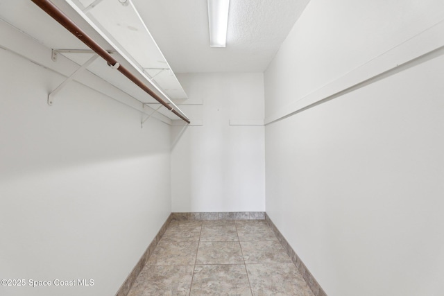 walk in closet featuring light tile patterned flooring