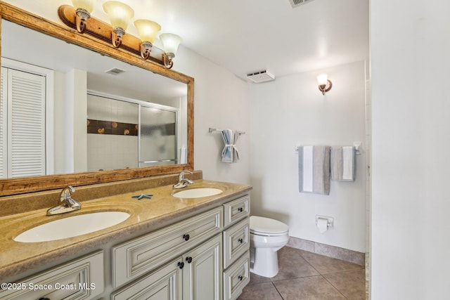 bathroom featuring walk in shower, tile patterned floors, toilet, and vanity