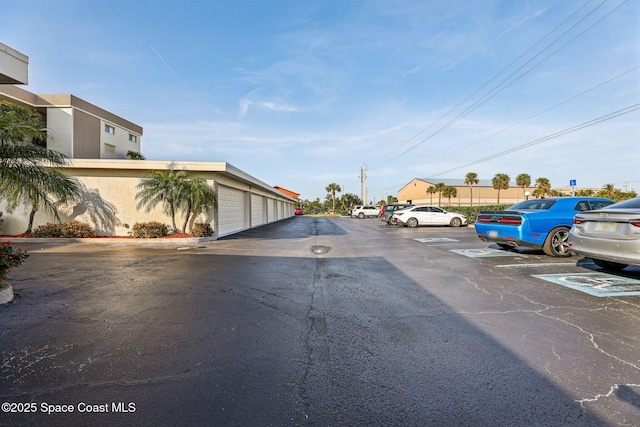 view of road featuring community garages