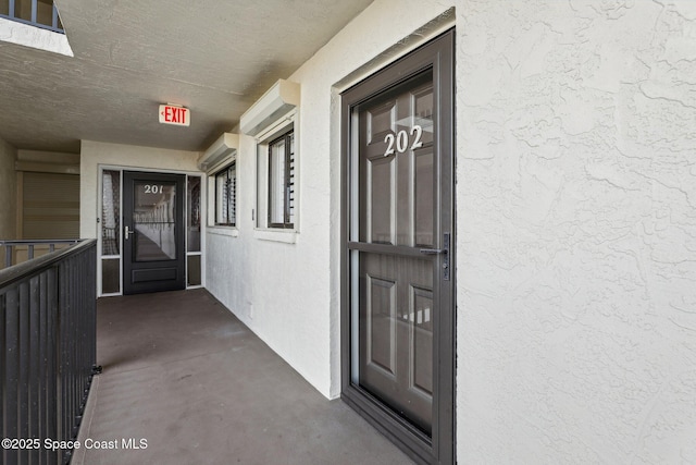 property entrance featuring stucco siding