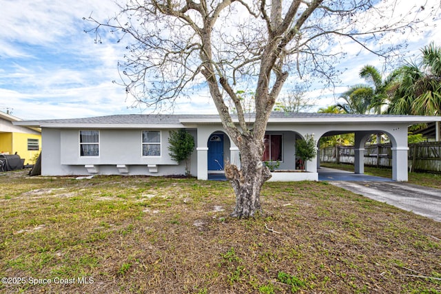 ranch-style home with a front yard and a carport